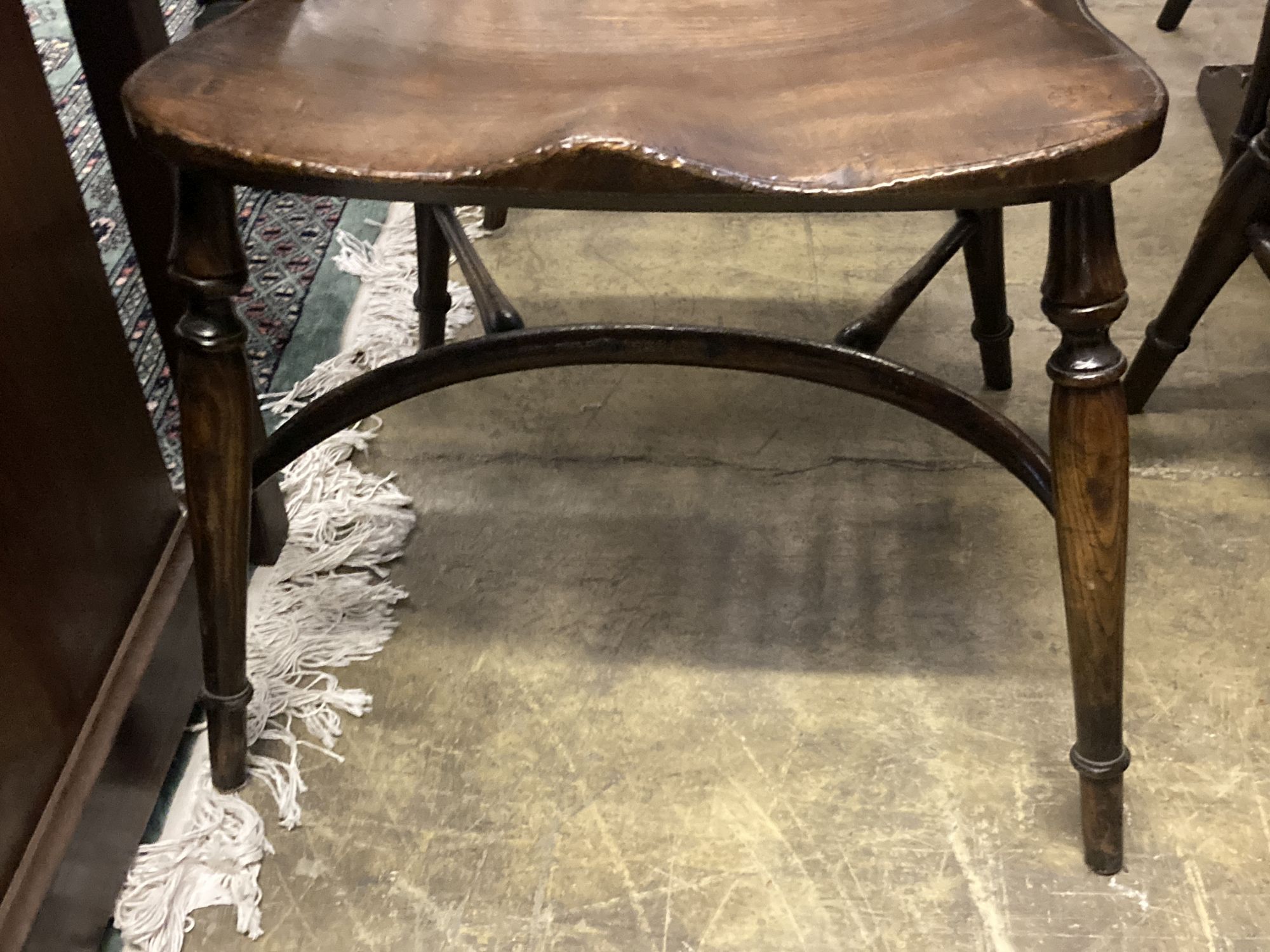 A set of ten stained ash and elm Windsor chairs with crinoline stretchers (two having arms)